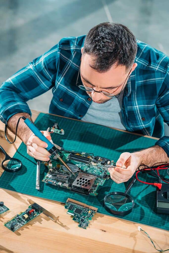Top view of engineer in glasses working with pc