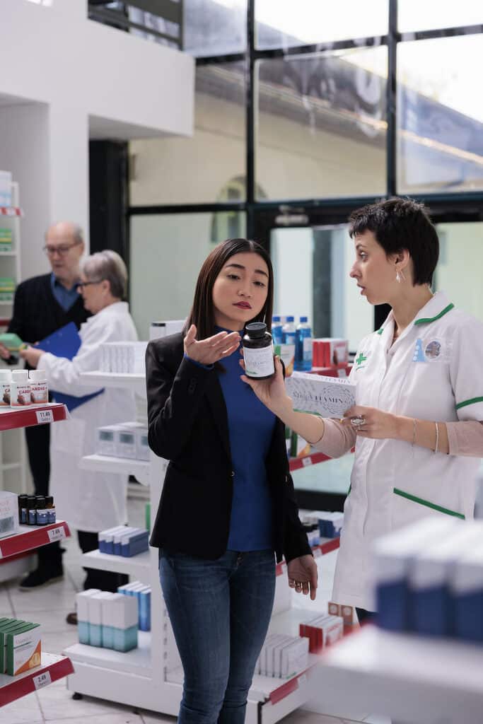 Young asian woman returning wrong vitamin package in drugstore